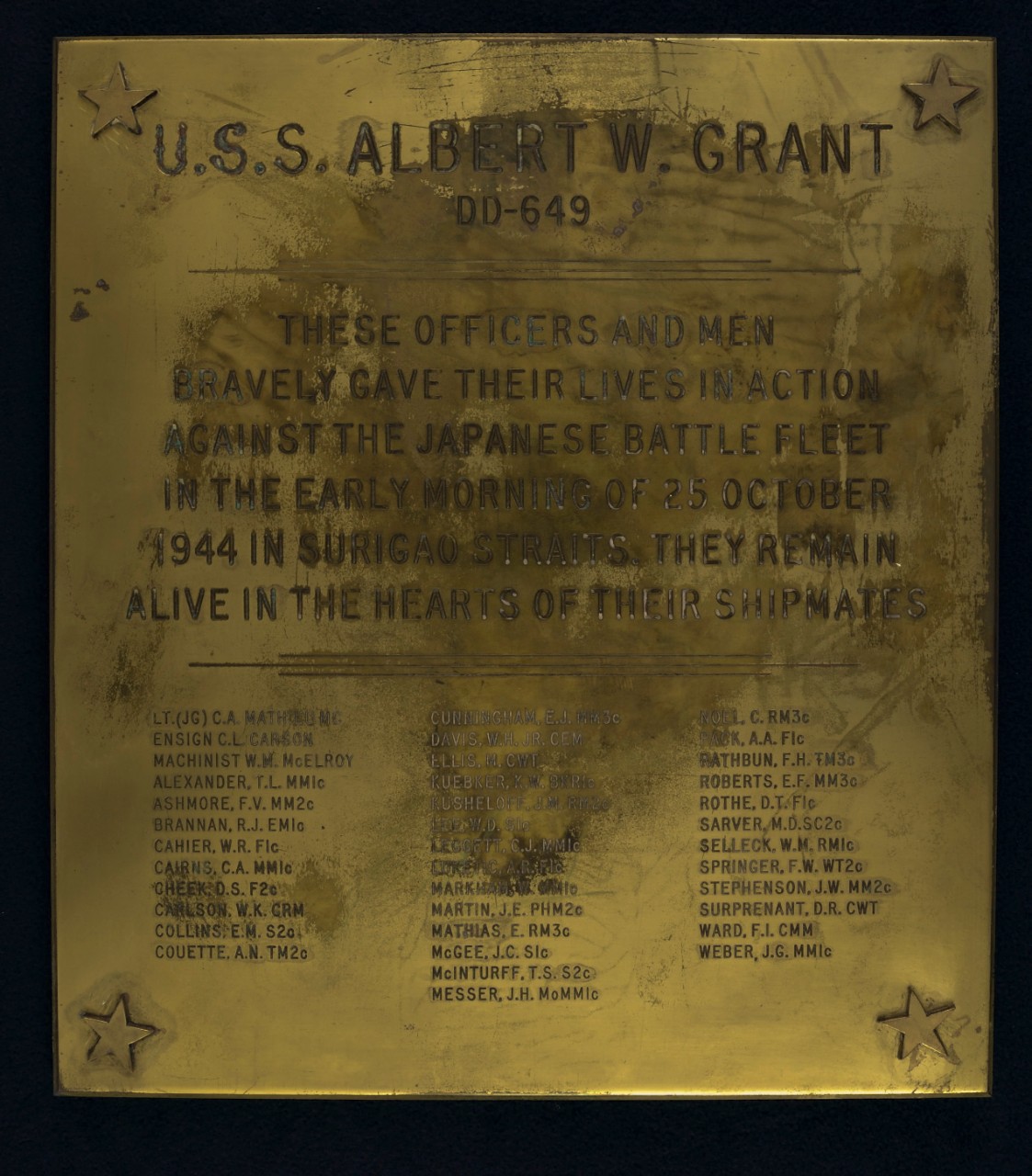 Brass Plaque with a star at each corner, name of the ship and hull number with text marking the battle of Surigao Straits and names of those lost