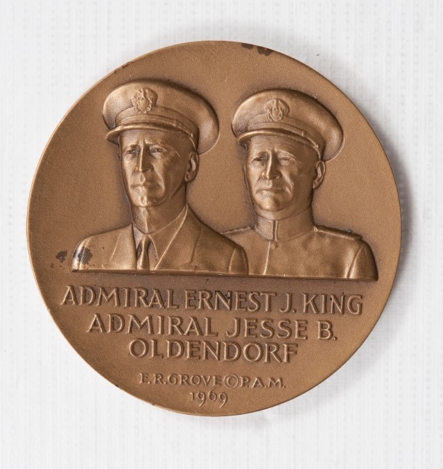 Bronze coin Obverse is Busts of Admirals Oldendorf and King in Navy Uniforms and Hats with names below