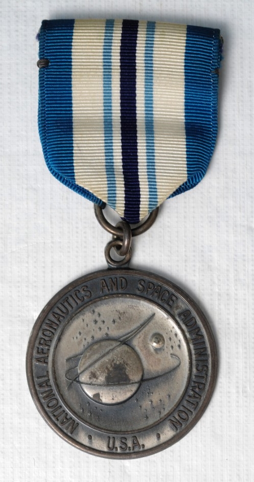 One Type I NASA Exceptional Service Medal. Medal is sterling silver. Planchet is the official Seal of NASA with "National Aeronautics and Space Administration/USA" around the rim. The reverse is oak branches around the rim with "Exceptional Servi...