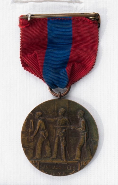 Reverse of West Indies Campaign medal raised image of soldiers with rifles