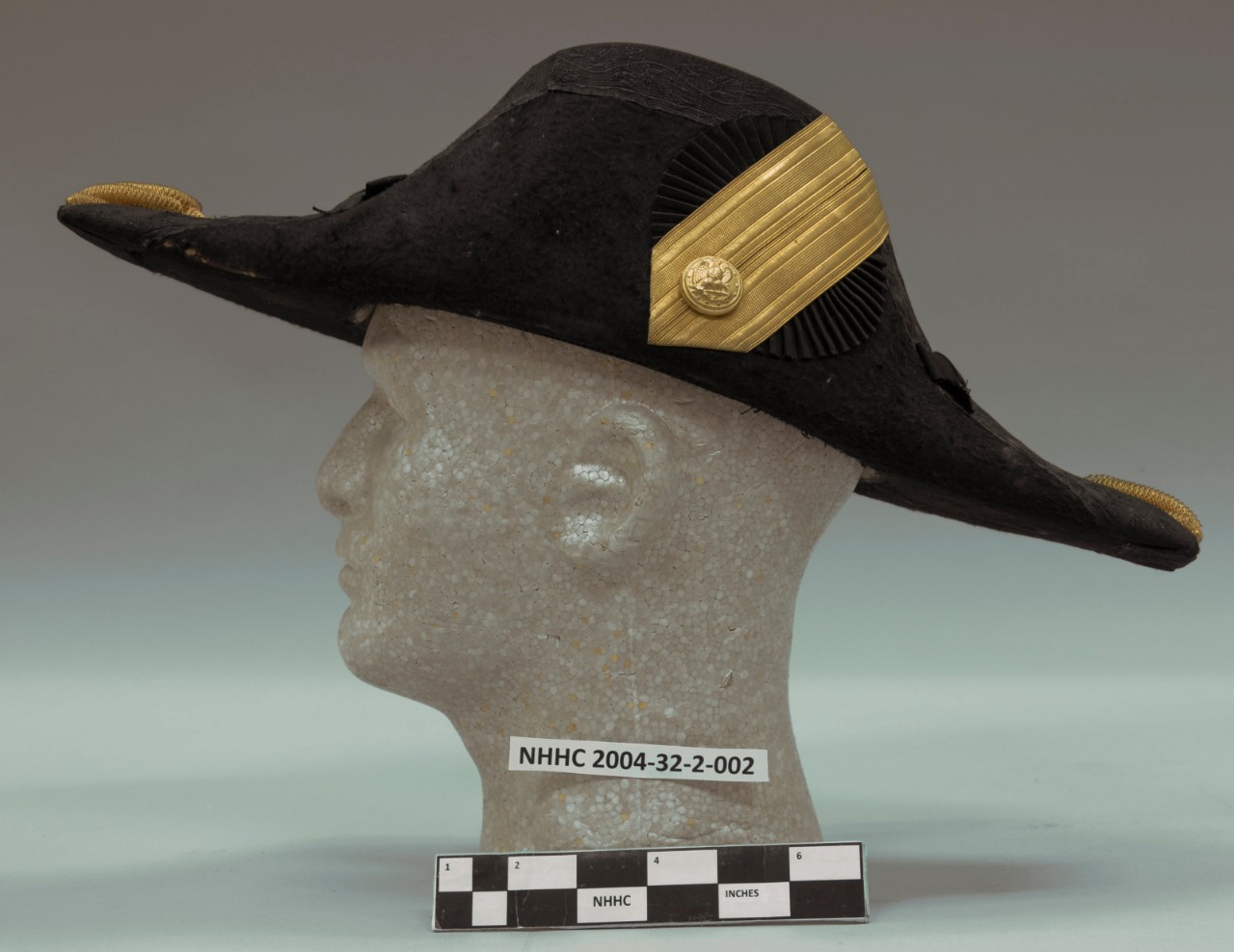 Bicorne Hat Left side view gold fabric ribbon with Navy button