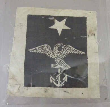 One white and black rating badge with eagle holding foul anchor and one white star above black field with white border