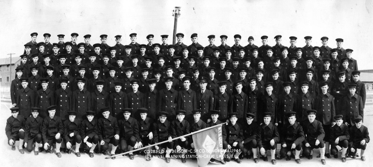 Collection of 21 oversized photographs related to the WWII naval service of John D. Anderson as a “Boot” Company Commander at Naval Training Center, Great Lakes, IL. The images consist of Great Lakes recruit (“boot”) companies from 1942-1945. CSp John D. Anderson is in most of the photos as Company Commander. Each image includes a company roster with member’s names. Below is a listing of each company with the date. Also included in the collection is a photo of Great Lakes Tenth Regiment during a Captain’s Inspection on 30 September 1944. 