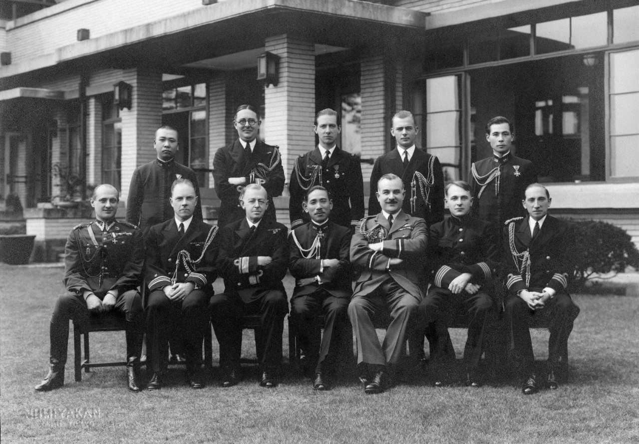 6 black and white photographs mounted in cardboard folders, including 5 oversize prints, of groups of international military officers in Japan, 1939-1941. Included are Xerox copies of the photographs with translations of the names originally printed in Japanese. Officers shown include representatives from Japan, United States, Great Britain, and Germany, along with spouses. Groups shown include the Invitational Tea Club of Foreign Officers and Spouses; Invitational Tea of Wives of Foreign Military Officers; army attachés; and Foreign Military Officers at Invitational Luncheon Club. Photos taken in Tokyo.