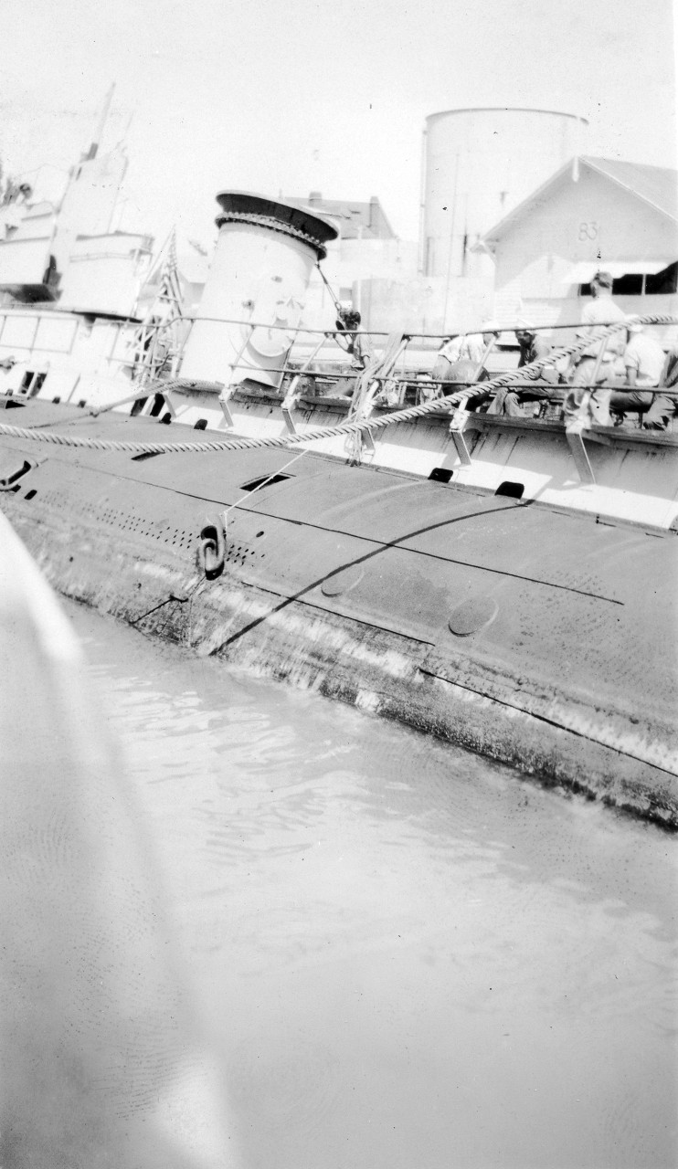 Salvaged S-4 heeled over to make repairs. Note ring attached to hull. Chains were attached to this ring for pontoon use.