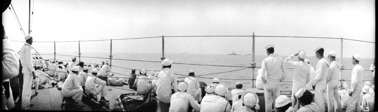 Enlisted sailors observe bombs striking the Ex-SMS Ostfriesland on the horizon during the 1921 Army-Navy bombing exercises off the Virginia capes.