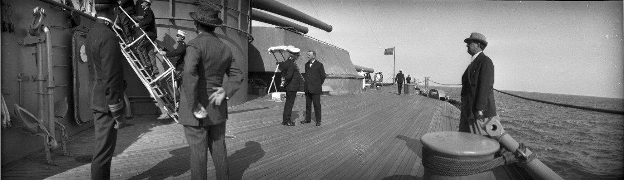 Secretary of the Navy Josephus Daniels speaks with an officer who may be Vice Admiral Hilary P. Jones, on board an unidentified US Navy battleship.