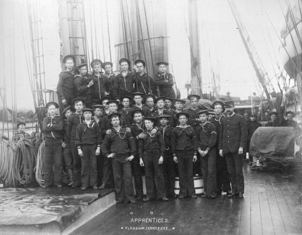Scrapbook containing crew photos and scenes on board USS Tennessee, circa 1885. Identified individuals include Rear Admiral James Jouett, Midshipman John Ellicott, Captain Oscar Stanton, Passed Assistant Engineer Robert Milligan. Many photos have been assigned NH numbers.