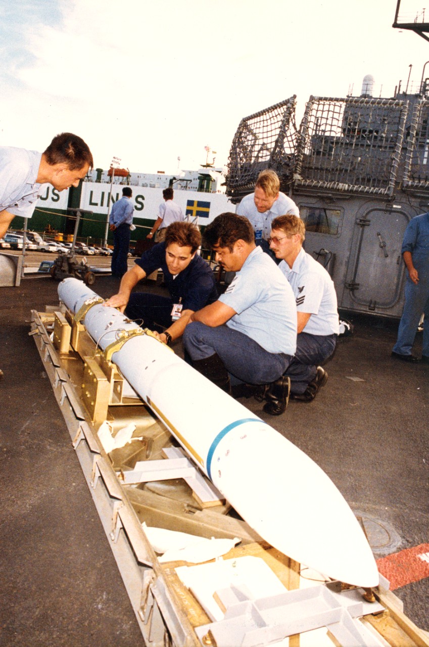 NSWC sailors work as part of a team in training ships' personnel in the operation and maintenance of combat and weapons systems. Petty Officer 1st Class Philip Onstott, briefs crewmembers on board USS Oldendorf (DD-972) on the proper procedure for loading the Sea Sparrow missile into the launcher. 