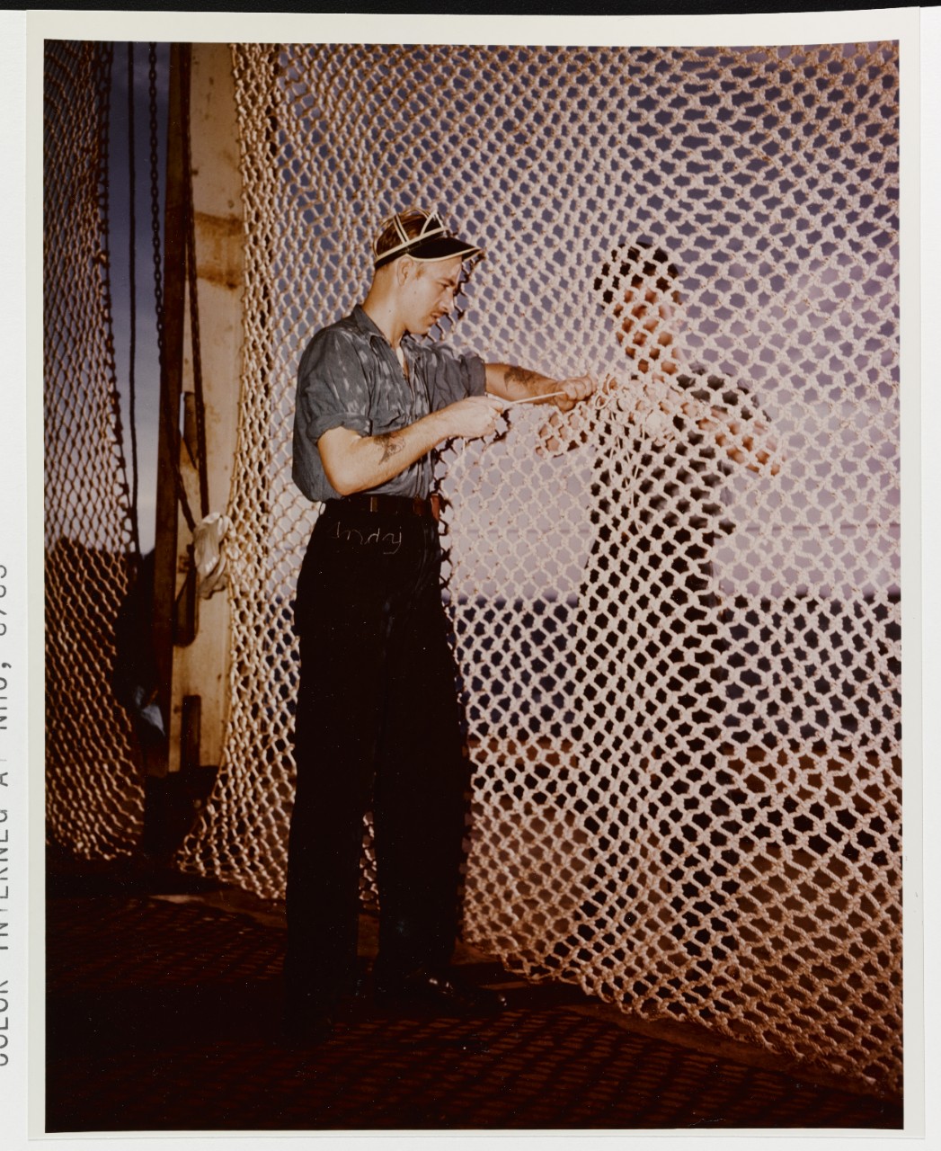 Mending nets on board an aircraft carrier