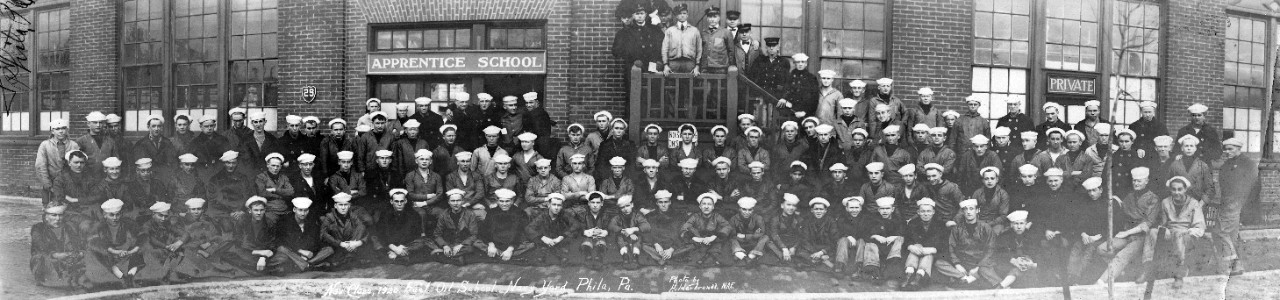 November 1920 class of the Fuel Oil School, Philadelphia Navy Yard, PA. Apprentice school is clearly labeled in the background.