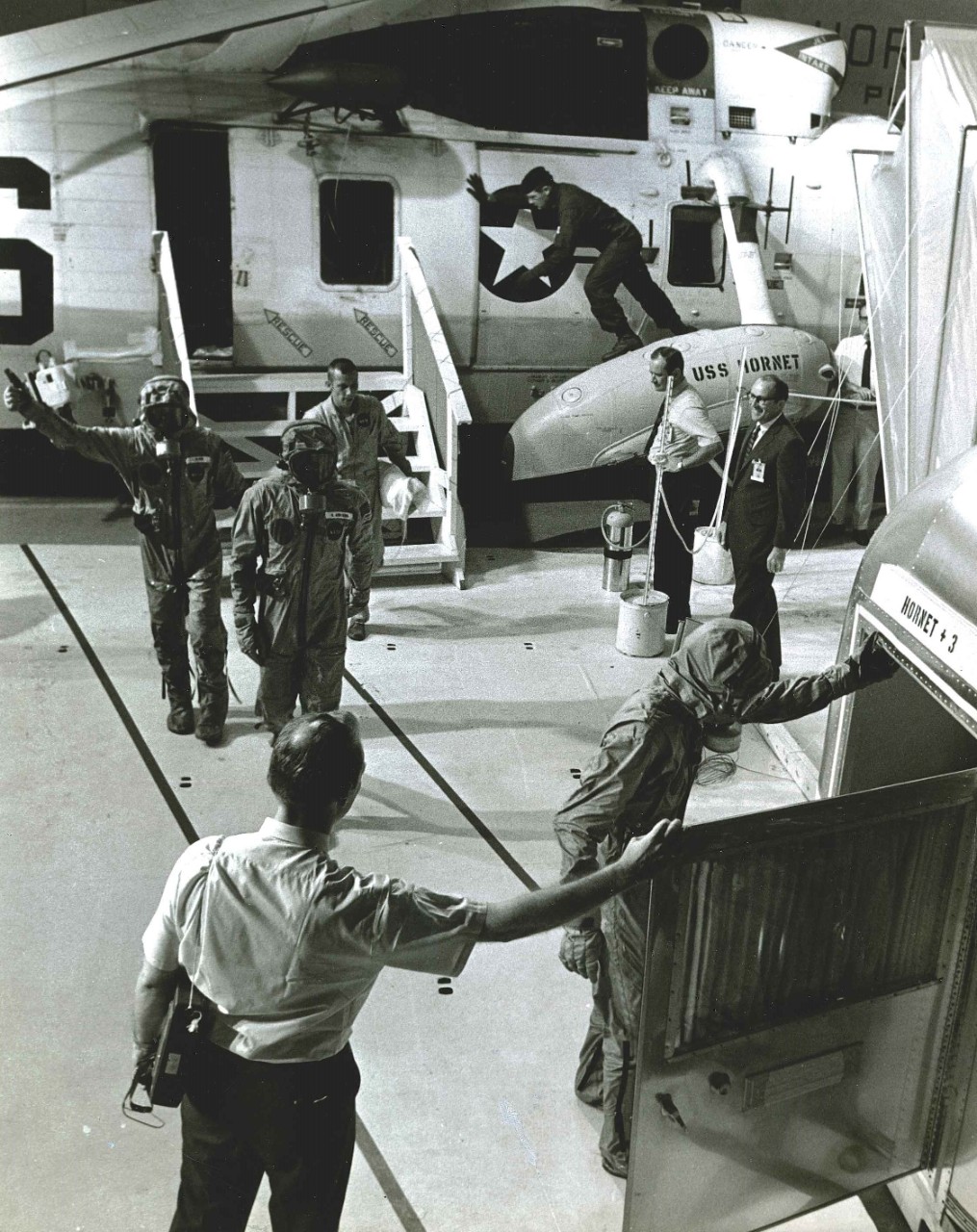 <p>Apollo 11 astronauts exit the helicopter and enter the Mobile Quarantine Facility.&nbsp;</p>
