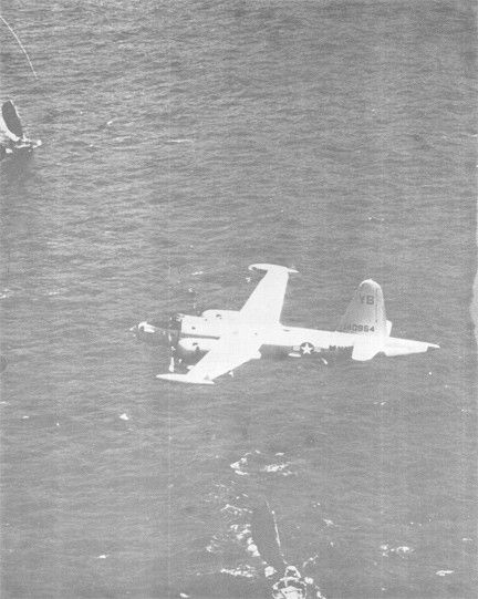 Image of An SP2H NEPTUNE Flies Low over Two Vietnamese Junks off the Coast of Vietnam