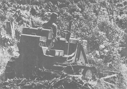 Image of Navy Seabee Clears a Site with His Bulldozer for a Missionary School in the Highlands of South Vietnam. Special SEABEE detachments Travel throughout South Vietnam building roads, constructing buildings and digging wells to assist the Sou...