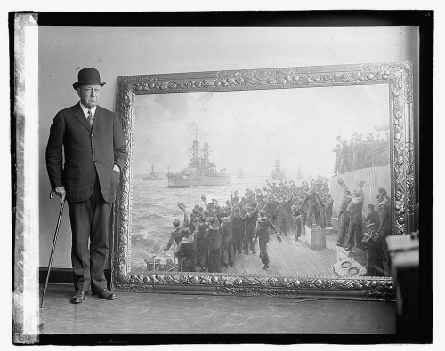 Admiral Hugh Rodman, USN, standing with the painting by Bernard F. Gribble "Arrival of the American Fleet" at Scapa Flow, December 1917 on the occasion of its arrival in Washington, D.C. shortly before the photo was published 10 April 1923. National Photo Company Collection (Library of Congress), LC-DIG-npcc-08177 (digital file from original).
