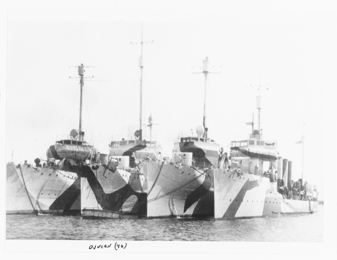 Destroyers moored at Brest, France, circa 1918. The right-hand ship is probably Ammen, second from left is Duncan (Destroyer No. 46). Note variations in application of “dazzle” camouflage. (Naval History and Heritage Command Photograph NH 100434)