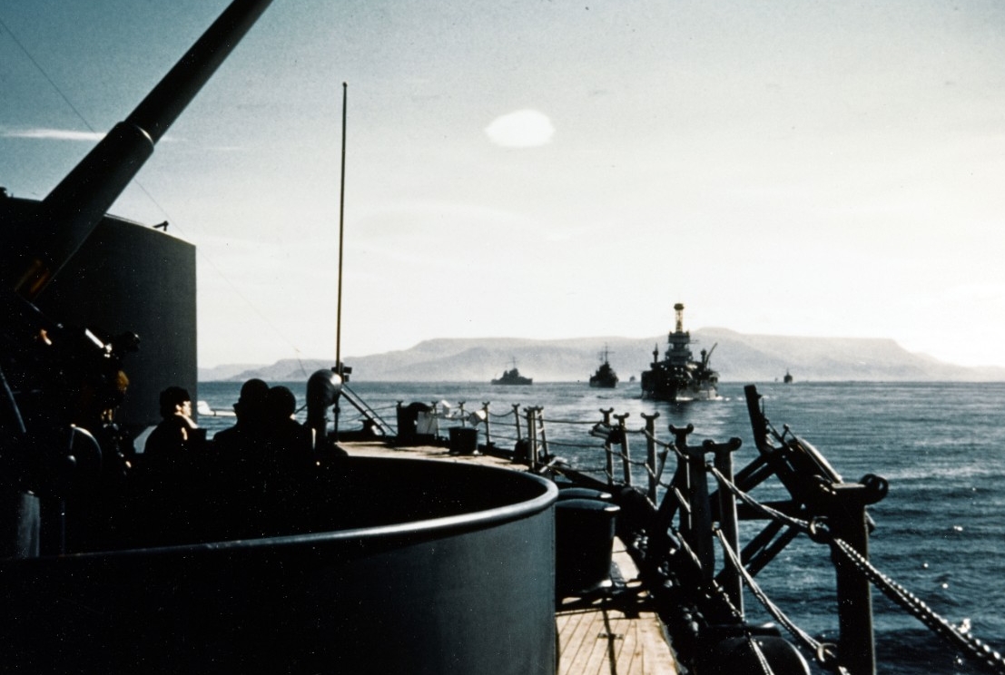 TF 19 sets sail from Reykjavik, Iceland, after landing the marines to help defend the country, 13 July 1941. Seen from the quarterdeck of New York, Arkansas is the next ship astern, followed by Brooklyn, and then Nashville. Note the 3-inch antiai...