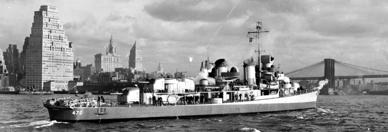 Against a backdrop of the iconic New York City skyline, Bethlehem Steel – the builders’ flag snapping from the port halliards -- Bache sets course for the New York Navy Yard for her commissioning, on 14 November 1942. Note that radar has not yet ...