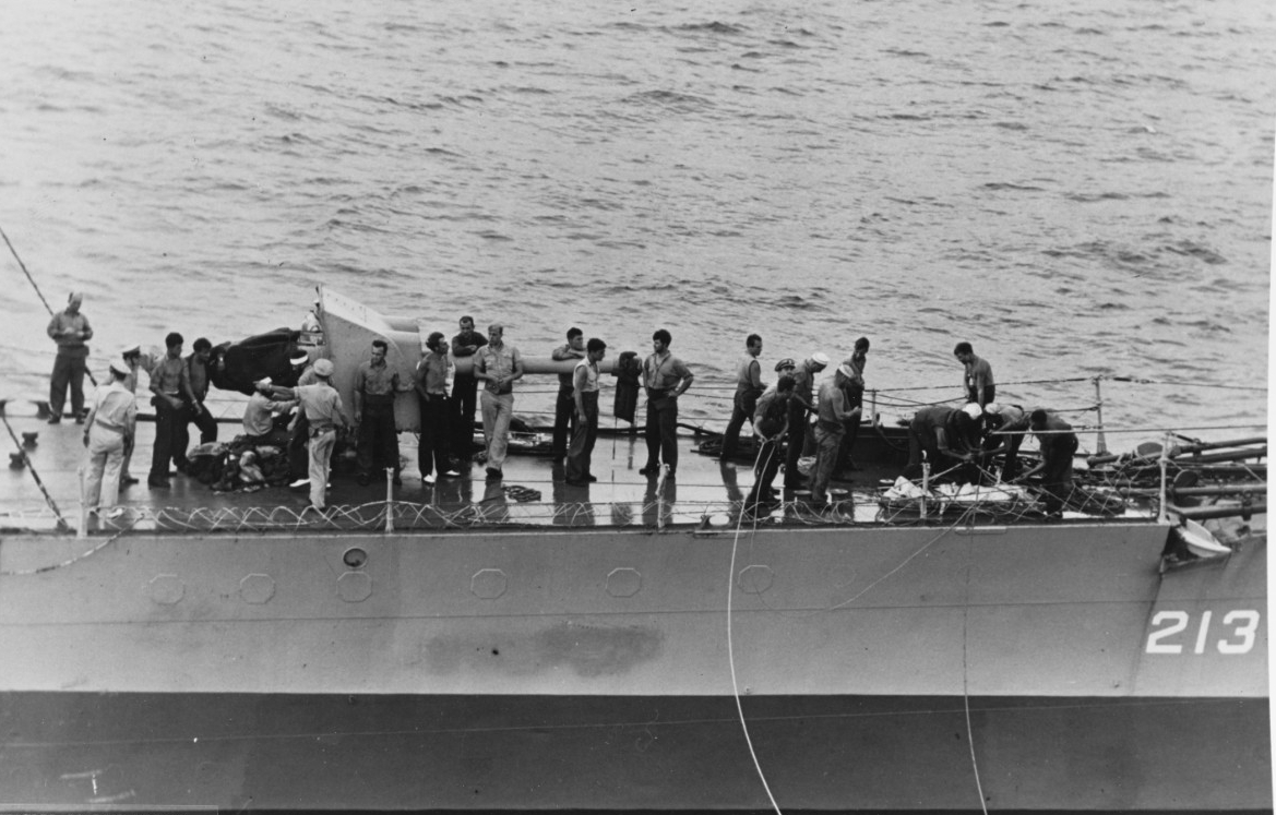 Barker lays alongside Core to transfer the prisoners, most of whom muster near the forward 4-inch gun, 24 August 1943. Note the cleared railings and the blanked off portholes. (Unattributed U.S. Navy Photograph 80-G-269039, National Archives and ...