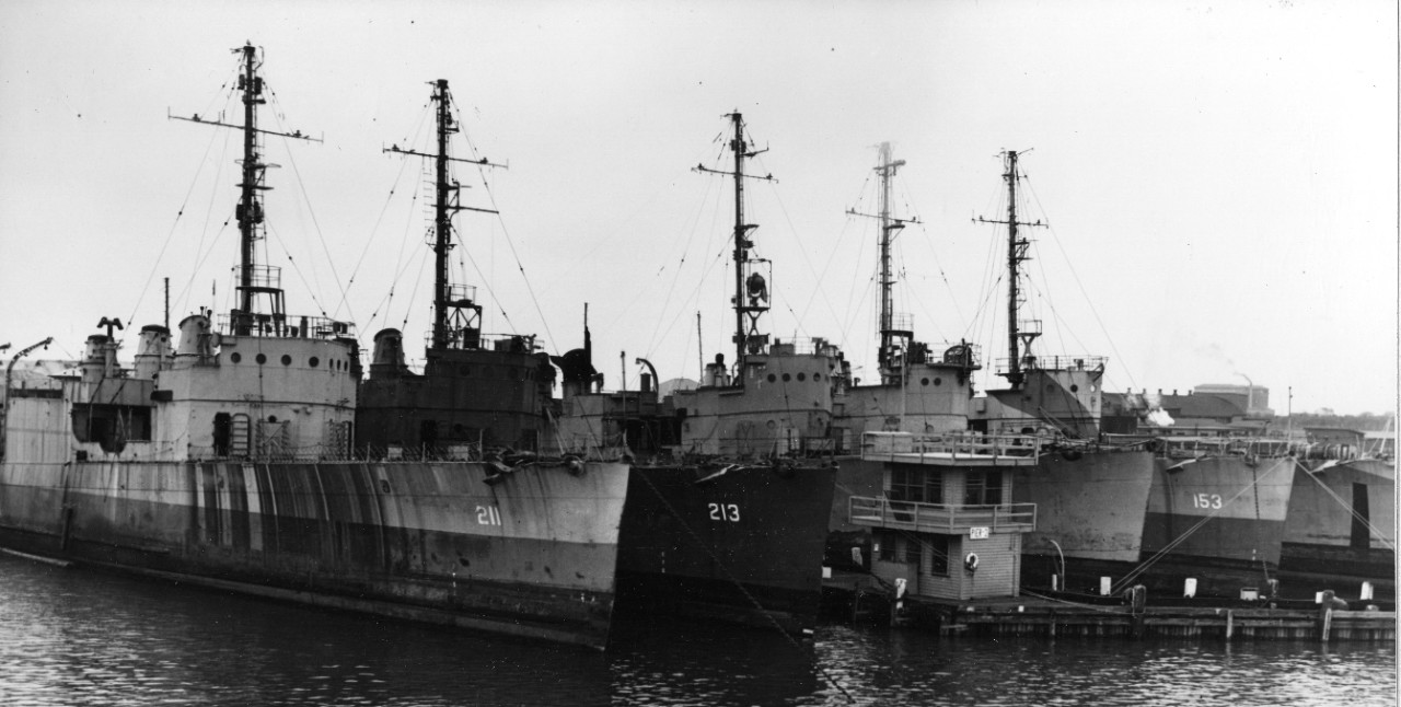Five sister ships await disposal at Cape May, N.J., 29 October 1945. From left to right they are: Alden (DD-211), Barker, unknown, Bernadou (DD-153), and unknown. The ship berthed next to Barker sports some victory markings on her upper bridge. (...