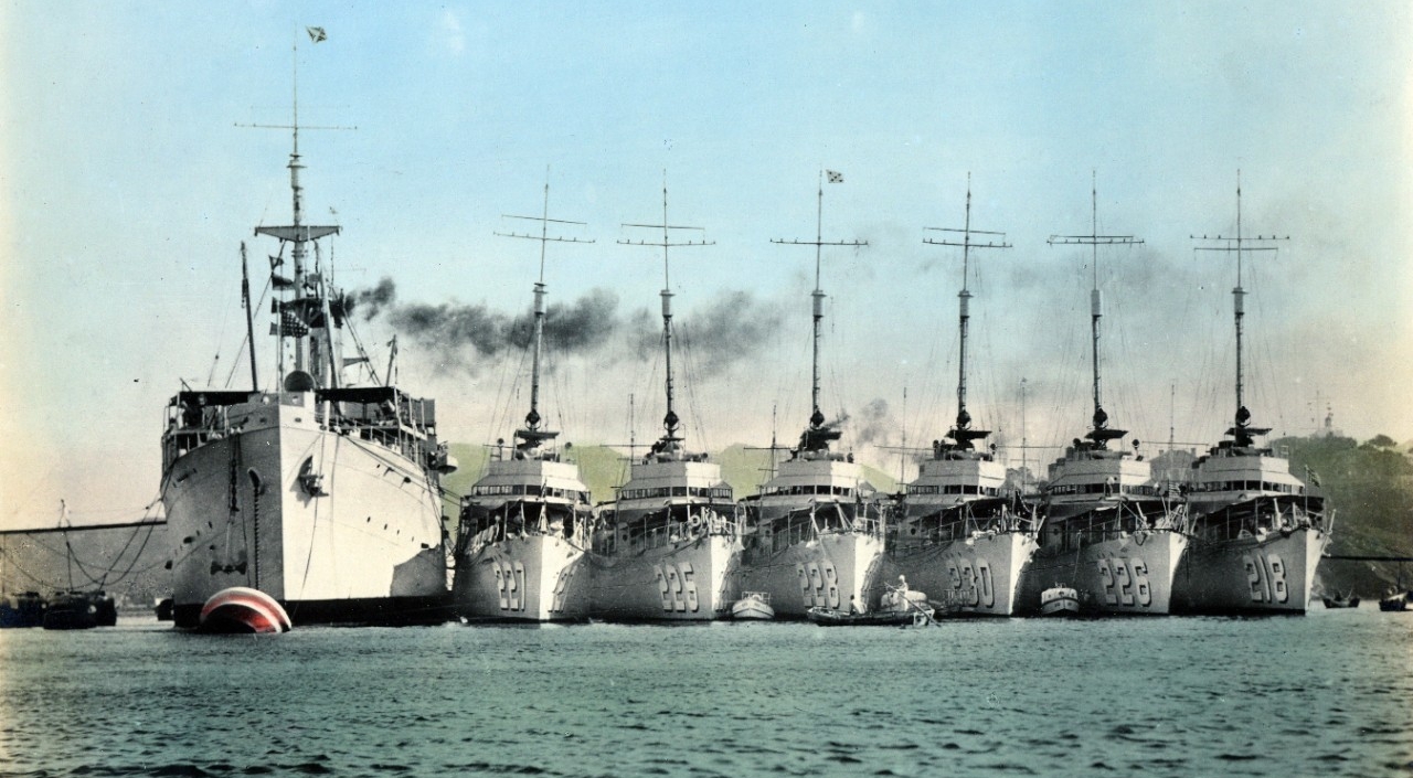 Black Hawk (color-tinted photograph by the Ah-Fung O.K. Photo Service) moored at Chefoo, China, during the 1930s. The six destroyers alongside include (from left to right): Pillsbury (DD-227); Pope (DD-225); John D. Ford (DD-228); Paul Jones (DD-...