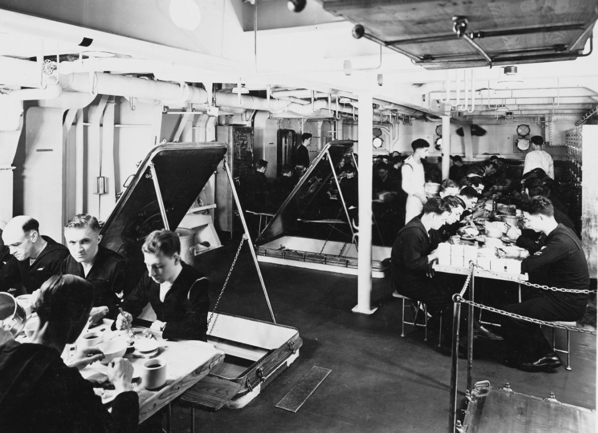 Sailors eat a meal on the mess decks, 18 January 1938. (Naval History and Heritage Command Photograph NH 56618)