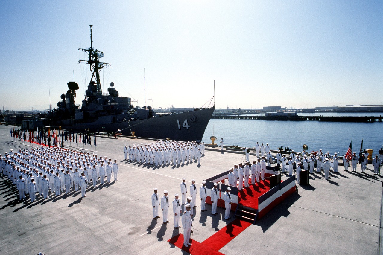 Participants stand at attention as a chaplain reads the benediction at the close of the decommissioning ceremony for Buchanan (left), Lynde McCormick (DDG-8), and Robison (DDG-12), 1 October 1991. (U.S. Navy Photograph 330-CFD-DN-ST-92-02406, Nat...