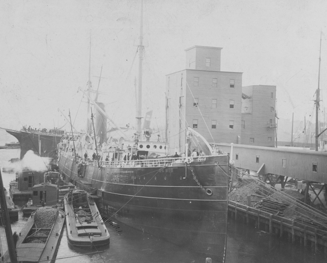 Nictheroy, formerly El Cid, fitting out for Brazilian Navy service in November 1893 at the Morgan Iron Works, New York, N.Y. Her former name, El Cid, has been painted out on the bow, but the ship still wears the rest of her mercantile paint schem...