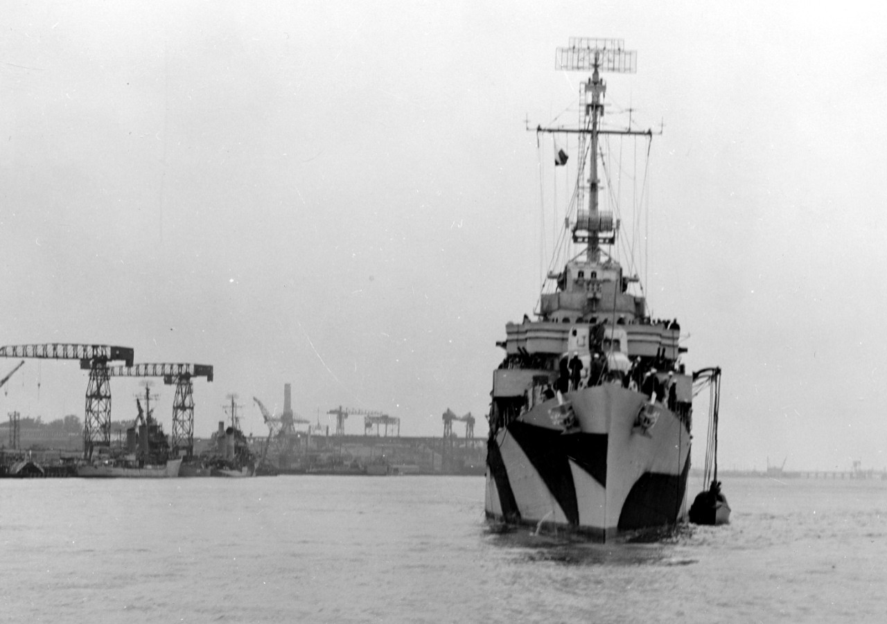 Bow-on view of Bush, 11 June 1944, as she appears to be recovering her gig, while ships can be seen along the waterfront of the Mare Island Navy Yard in various stages of repairs and alterations in the left background. (U.S. Navy Bureau of Ships ...