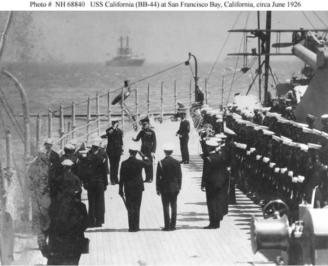 California and 67 other ships of the Battle Force, its screen, and auxiliaries steam into San Francisco Bay for a brief visit, 18 June 1926. Capt. William H. Standley, California’s commanding officer, exchanges salutes with Brig. Gen. Smedley D. Butler, USMC (both of whom stand just left of the center of the picture). Note the marine guard and ship’s band to the right. (Courtesy of the San Francisco Maritime Museum) (Naval History and Heritage Command Photograph NH 68840)