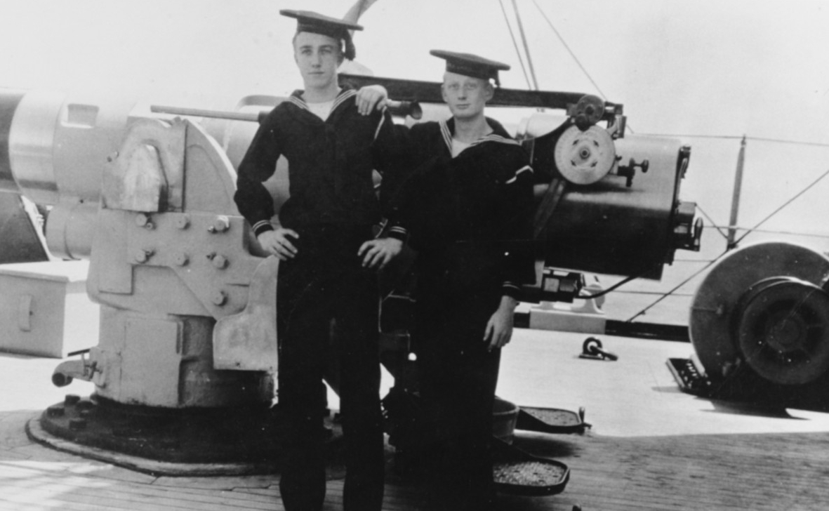 Ordinary Seamen J.A. York (left) and James B. Dofflemeyer of the ship’s company stand by her forecastle 6-inch gun, 9 May 1909. (Naval History and Heritage Command Photograph NH 83105)