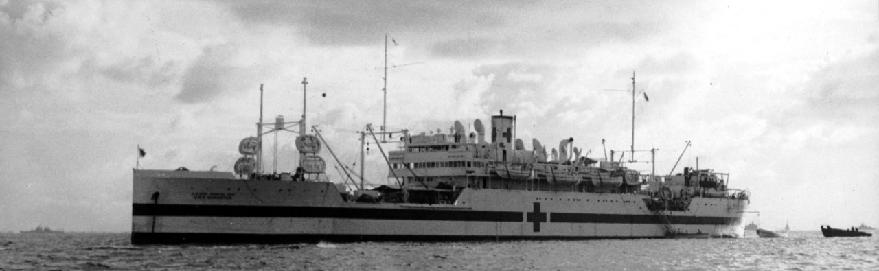 Samaritan anchored at Ulithi, 30 October 1944. Painted white, with red crosses and green bands on her hull, she also carries her full designation: U.S. NAVY HOSPITAL SHIP U.S.S. SAMARITAN in black, painted on both sides of her bow and stern. (U.S...