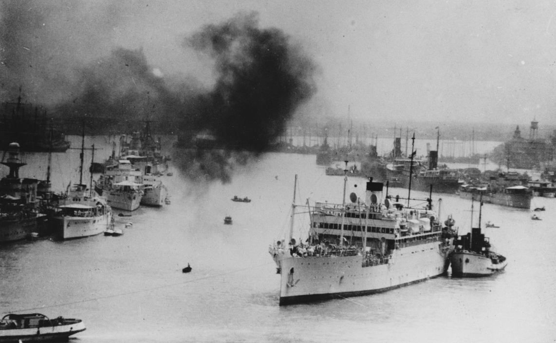 Chaumont arriving at Shanghai with the Sixth Marine Regiment on 19 September 1937. Assisted by the tugs St. Sampson and St. Dominic, she is preparing to moor in “Man of War Row” in the Whangpoo [Huangpu] River off the Bund. The ships moored in th...