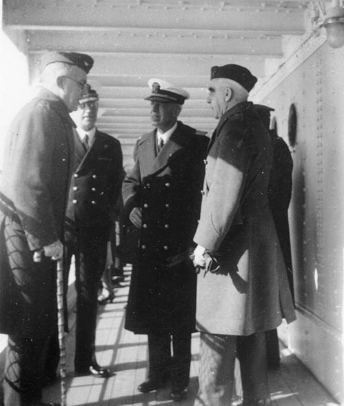 Adm. Harry E. Yarnell, Commander in Chief, U.S. Asiatic Fleet, (middle, white cap cover) on board Chaumont at Shanghai on 18 February 1938. With him are: Brig. Gen. John C. Beaumont, USMC, commanding the Second Marine Brigade, (left); Cmdr. Lemue...