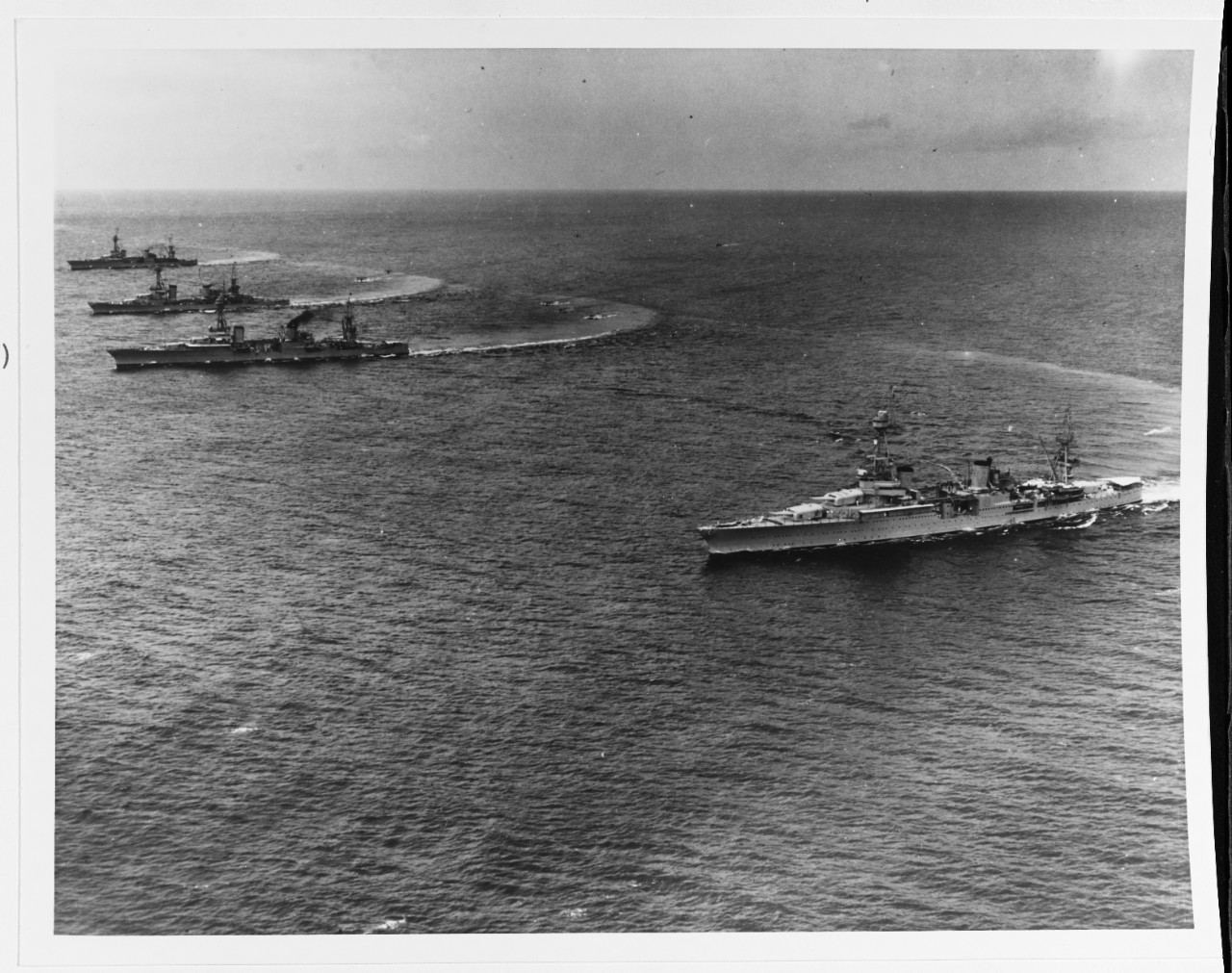 Chicago (right) demonstrates her nimble turning abilities as Scouting Force heavy cruisers turn to create a slick for floatplanes to land during maneuvers in Hawaiian waters, 31 January 1933. The other cruisers are (front to back) Louisville (CA-...