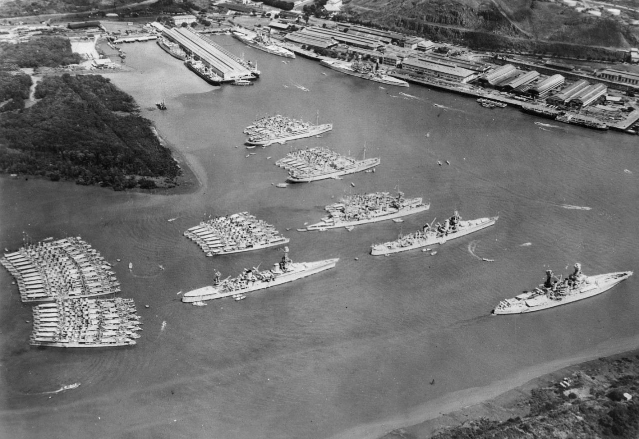 An aerial view of ships of the Scouting Force at Balboa in the Panama Canal Zone during maneuvers, 1934. Some of the vessels identified include: Chicago, Indianapolis (CA-35), Goff (DD-247), McFarland (DD-237), and destroyer tenders Dobbin (AD-3)...