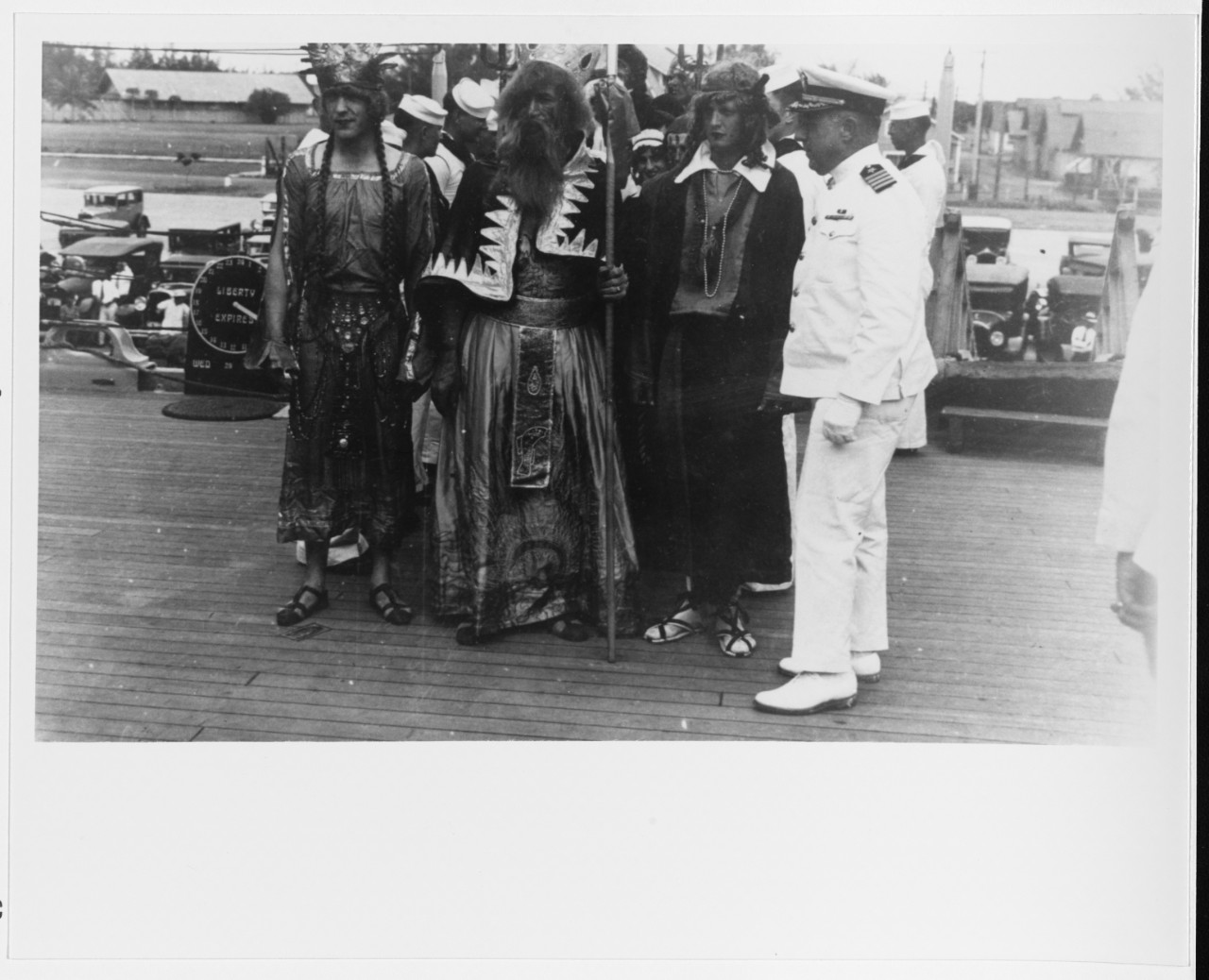 Capt. Manley H. Simons, Chicago’s commanding officer, welcomes King Neptune and his court on board the cruiser while she crosses the equator, not far from Pago Pago, 1931. Note the liberty clock in the background. (Courtesy of Wiley H. Smith, Nav...
