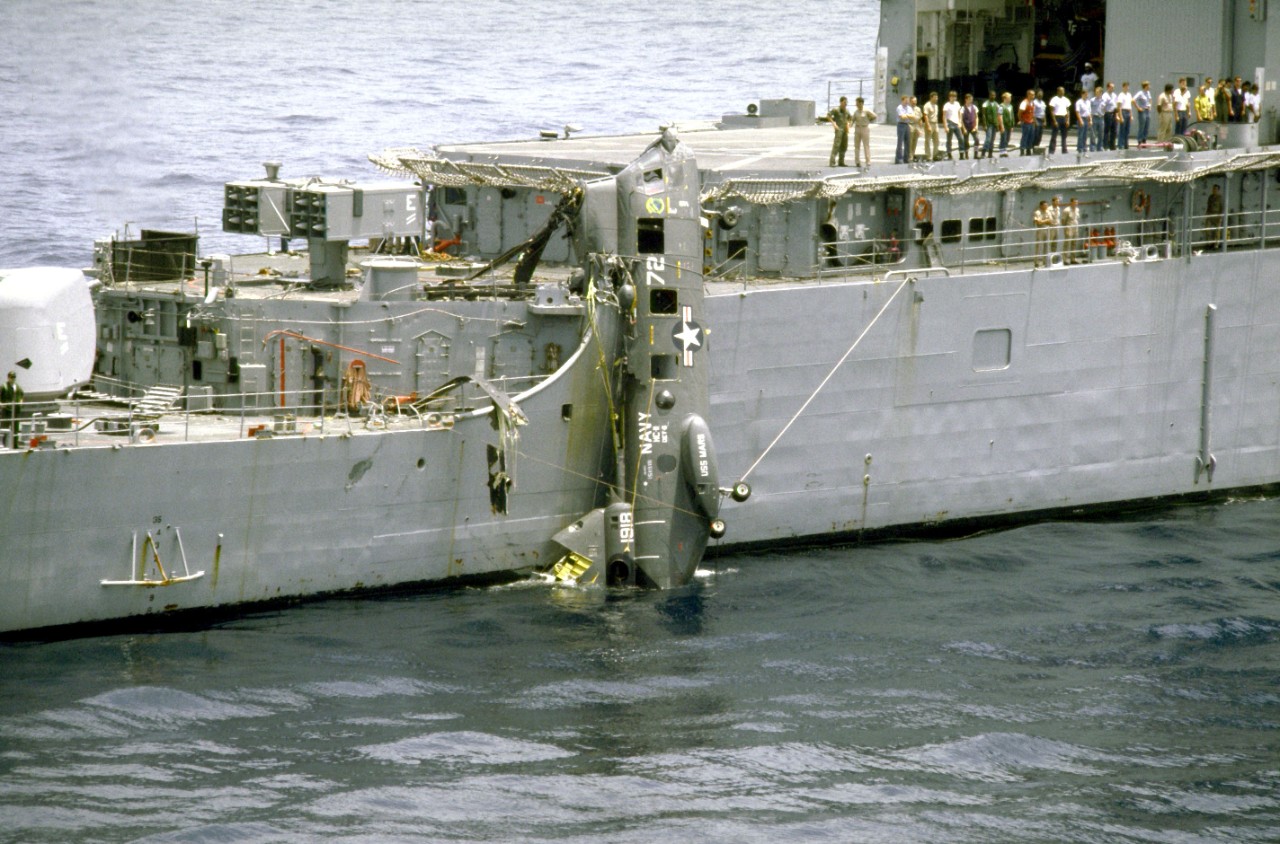 A CH-46 hangs off the side of Fife. One of Cook’s crew and some of its cryptographic equipment were on board at the time of the crash. Fortunately, both were unharmed. (U.S. Navy Photo by PH3 Hensley, DIMOC DN-ST-87-10141)