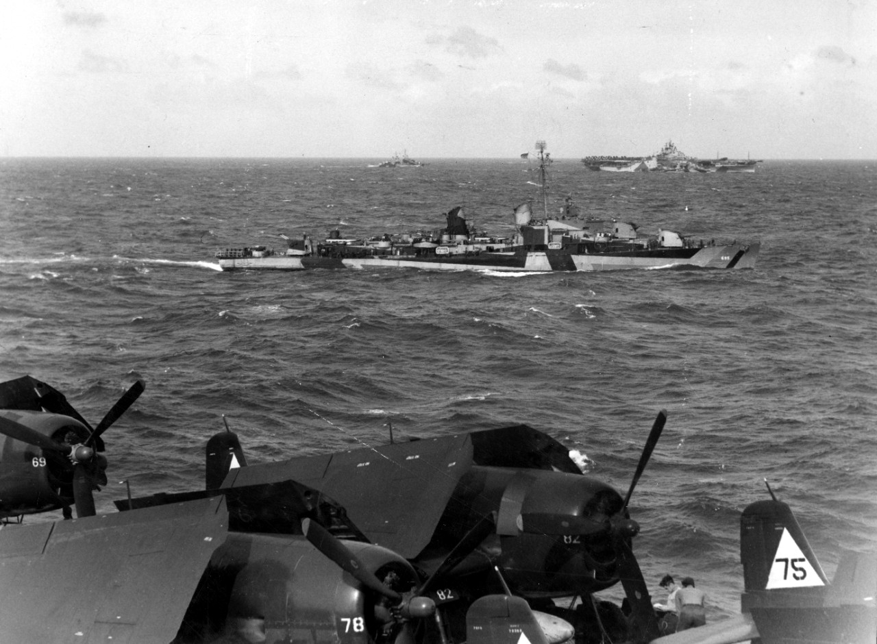 In this view that shows the starboard side pattern of her Measure 32 Designed 3D camouflage, Cooper steams with TG 38.4, 7 November 1944, as seen from Enterprise. Carrier in the distance (R) is Yorktown (CV-10). (U.S. Navy Photograph 80-G-288414,...