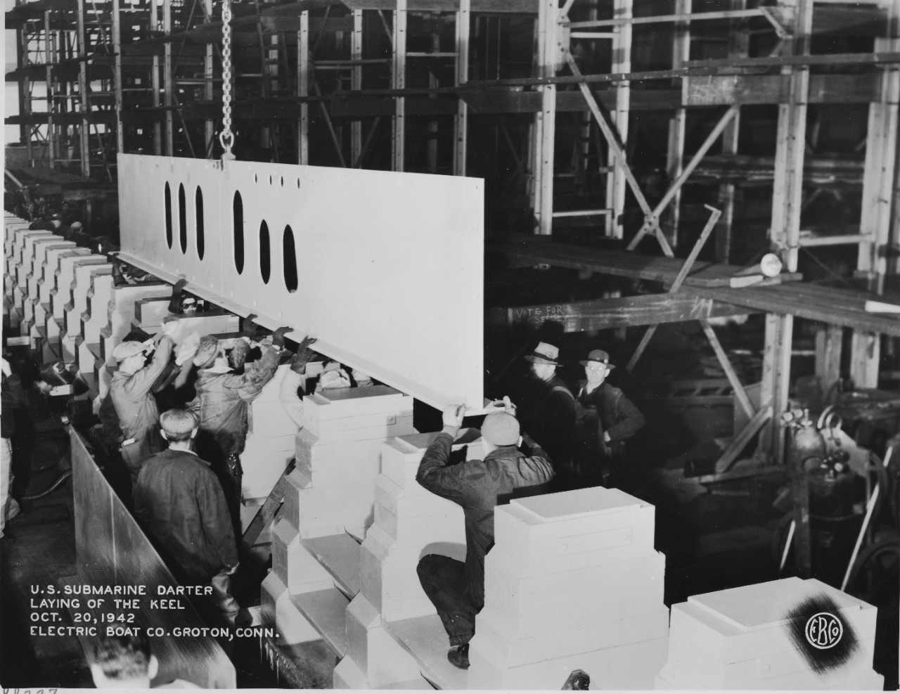 With some of the workmen wearing their identity badges on their hats or caps, Darter’s keel is laid on an autumn day in Groton. (U.S. Navy Bureau of Ships Photograph 19-LCM-SS 227-1, National Archives and Records Administration, Still Pictures Di...