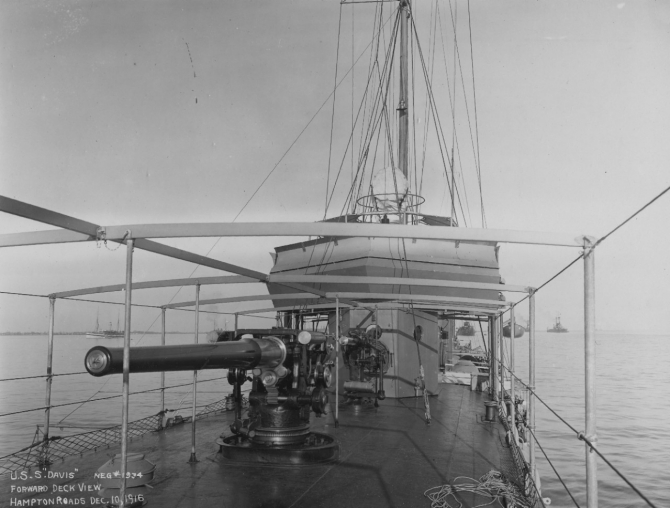 Close-up of Davis’ forward 4-inch mount, with the 1-pounder antiaircraft gun in the background, Hampton Roads, 10 December 1916. Part of the supports for the foc’sle awnings obscure some details of the bridge. Hospital ship Solace lies anchored in the distance (left). (U.S. Navy Bureau of Ships Photograph 19-N-1934, National Archives and Records Administration, Still Pictures Branch, College Park, Md.)