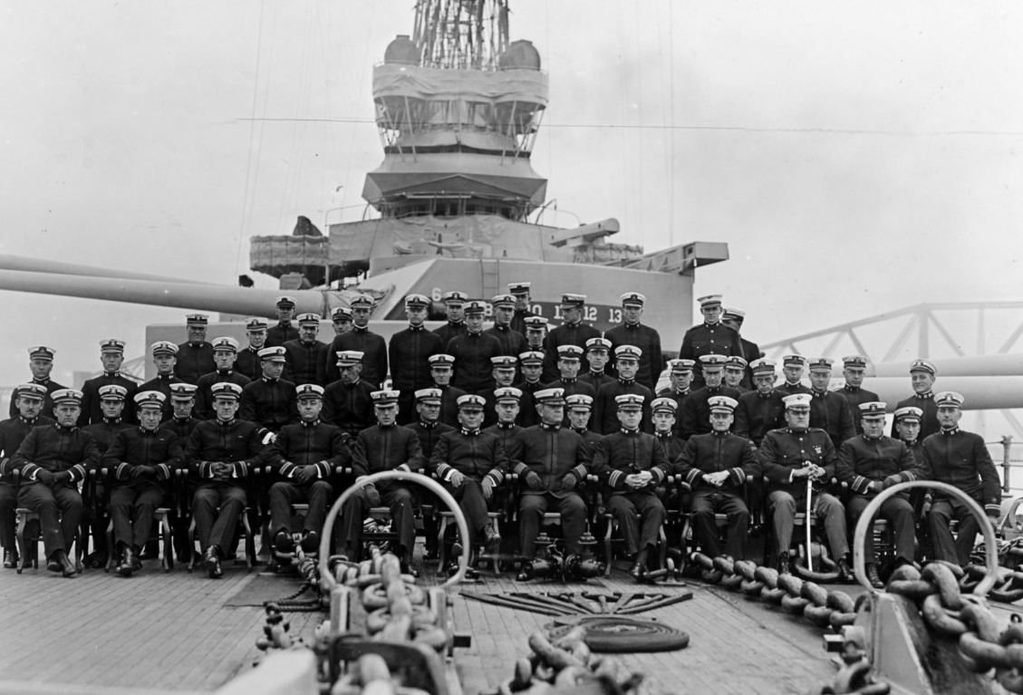 Delaware’s officers, 1918, with Capt. Archibald H. Scales, her commanding officer, seated in the front row, center. Photographed in the Firth of Forth, Scotland, with the Forth Bridge visible in the background. Collection of Lieutenant Commander ...