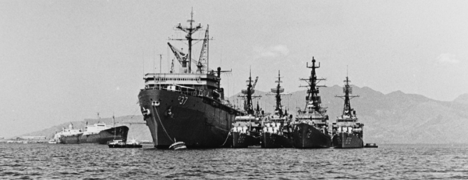 The ship lays alongside Samuel Gompers (AD-37) for repairs, most likely at Subic Bay, Philippines, May 1969. The ships nested with the destroyer tender are (left to right) Higbee (DD-806), Douglas H. Fox, Robison (DDG-12), and Leary (DD-879). (PH3 Stephen L. Howk, U.S. Navy Photograph USN 1139041, Photographic Section, Naval History and Heritage Command)