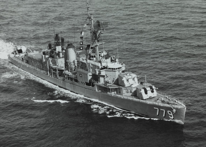 A starboard bow view of the ship shows her following the FRAM II conversion. Note the enhanced communications and radar antennae, and the DASH hangar and flight deck aft. (Unattributed U.S. Navy Photograph NH 99977, Photographic Section, Naval History and Heritage Command)