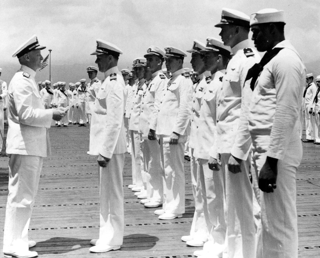 Adm. Nimitz awards Lt. Cmdr. McClusky the Distinguished Flying Cross during a ceremony on the flight deck of Enterprise at Pearl Harbor, 26 May 1942. MATT2c Doris Miller, who receives the Navy Cross for his valorous actions during the Japanese at...