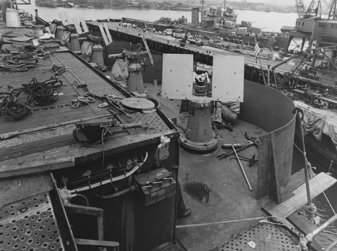 This view shows some of the 20 millimeter guns being installed at Pearl Harbor Navy Yard, 19 March 1942. Fanning (DD-385) and Gridley (DD-380) are moored nearby (right background). (Naval History and Heritage Command Photograph NH 81081)