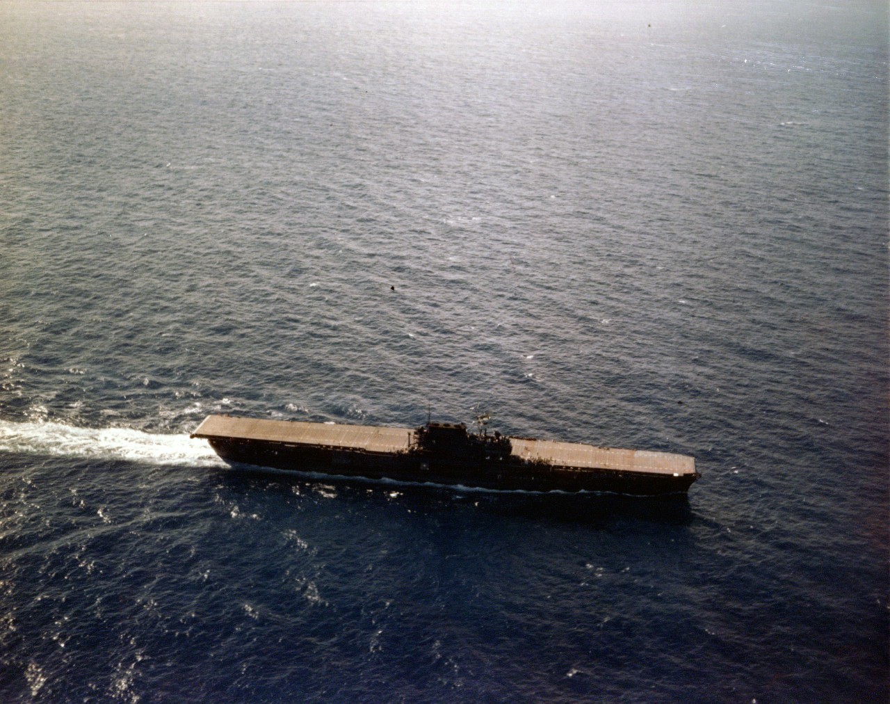 Enterprise turns into the wind to recover planes while steaming in the Pacific, circa June 1941. Note her natural wooden flight deck stain and the Measure 1 camouflage paint scheme. The following month the ships company will stain her flight deck...