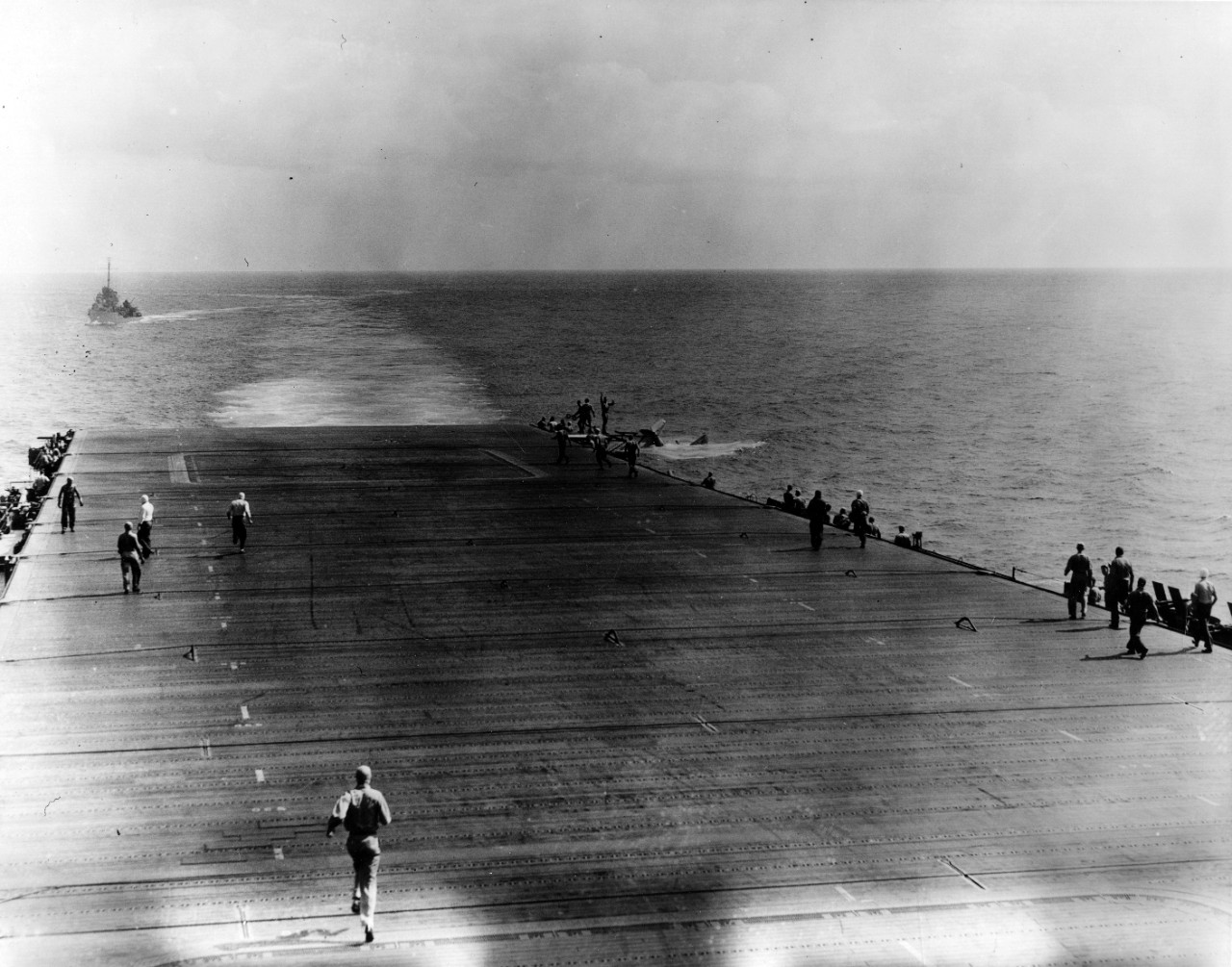 Lt. Cmdr. Eugene E. Lindsey’s Douglas TBD-1 Devastator (BuNo. 0370) sinks astern of Enterprise after a deck landing accident, 28 May 1942. Monaghan steams as the plane guard destroyer in the left background, and rescues Lindsey and his crew. Ente...