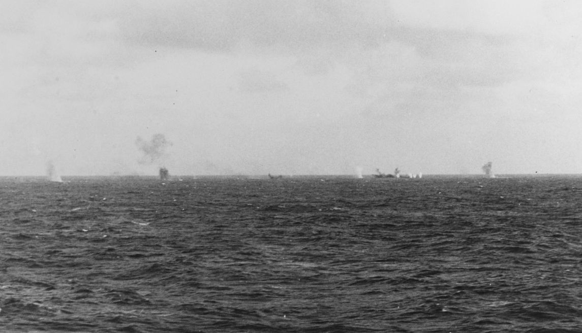 Balch, Maury, and planes from Enterprise sink one of the Japanese guardboats (right — black smudge) off Wake, 24 February 1942. A man on board Salt Lake City snaps the shot. (Naval History and Heritage Command Photograph NH 50949)