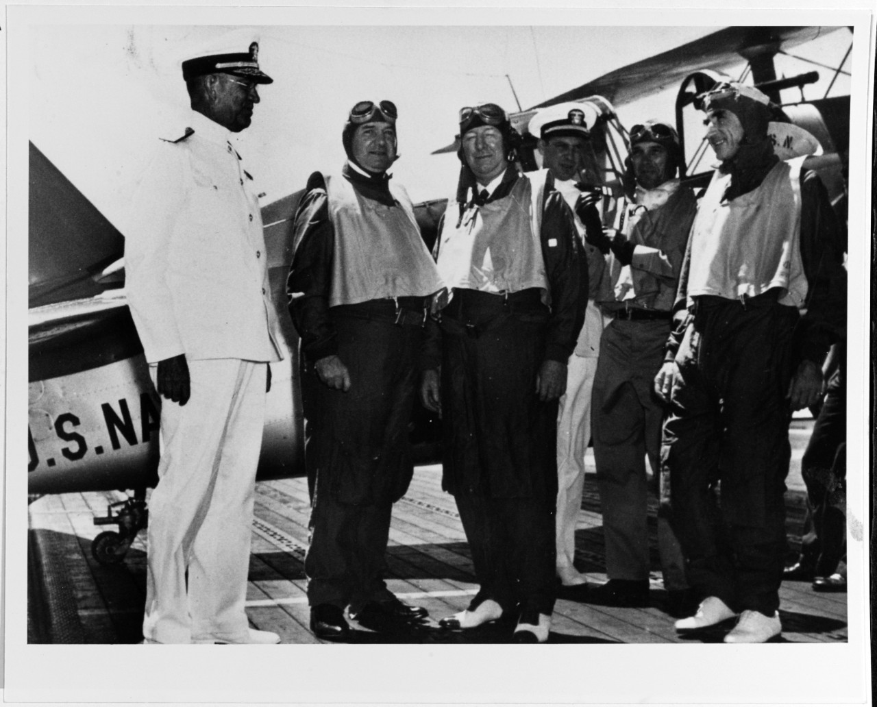 Secretary of the Navy Frank Knox (center) prepares for his flight from Enterprise to NAS Pearl Harbor, 13 September 1940. Additional men in the picture include: Adm. Richardson (left); Cmdr. Morton L. Deyo; and Lt. Cmdr. Edward C. Ewen, Enterpris...